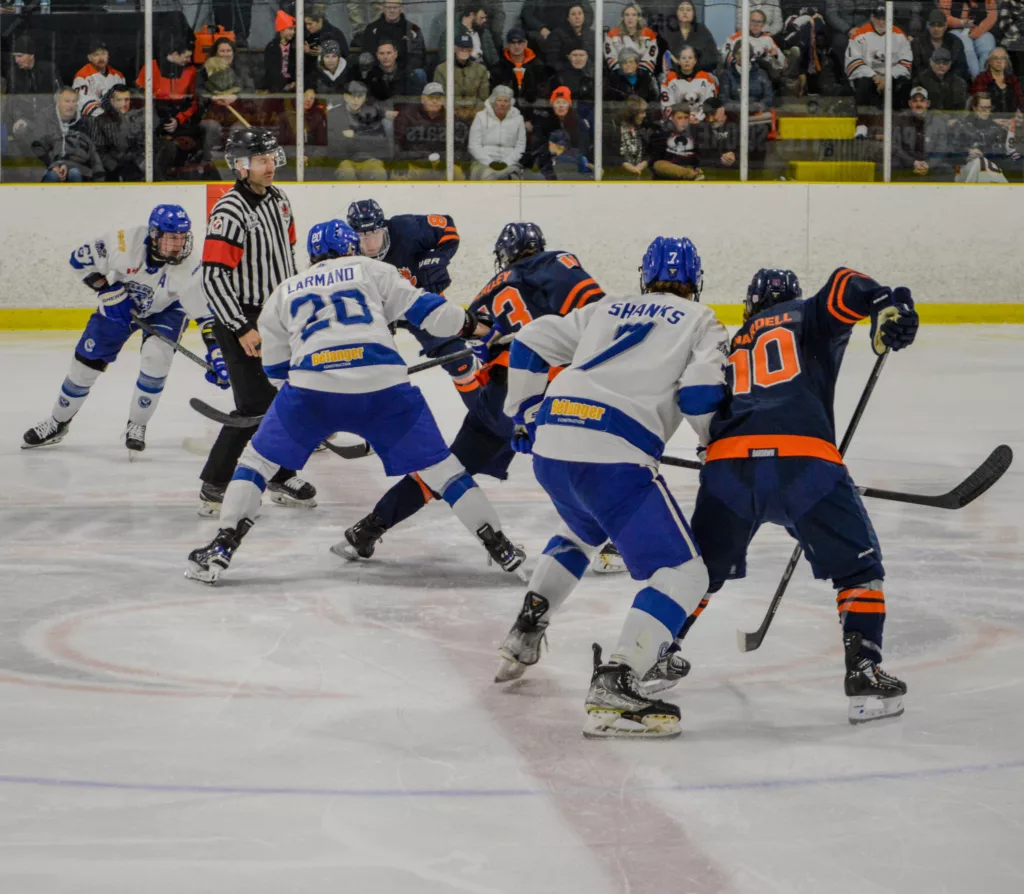 Cubs and Thunderbirds fight for the puck after a face-off in Game 3 on Monday, March 25